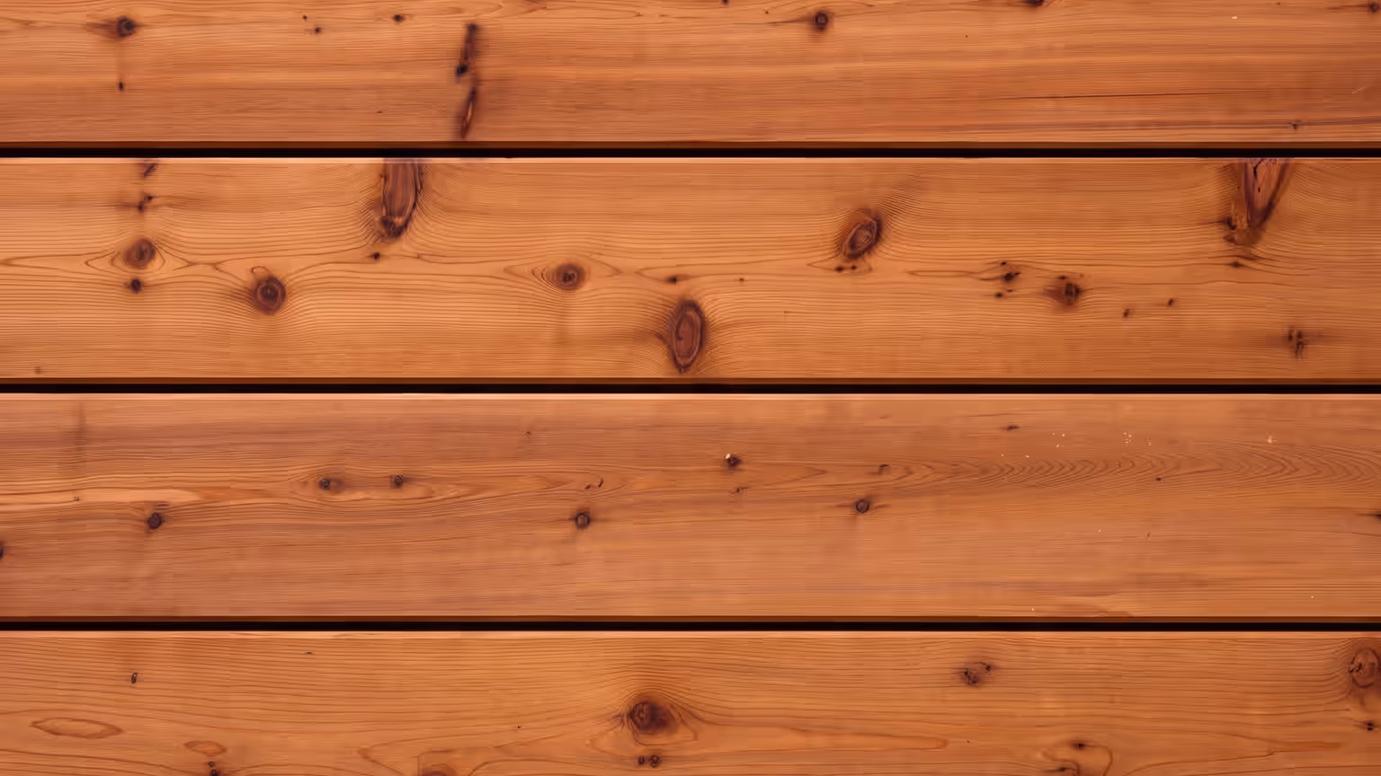 Warm reddish-brown cedar deck boards with tight dark knots and straight grain