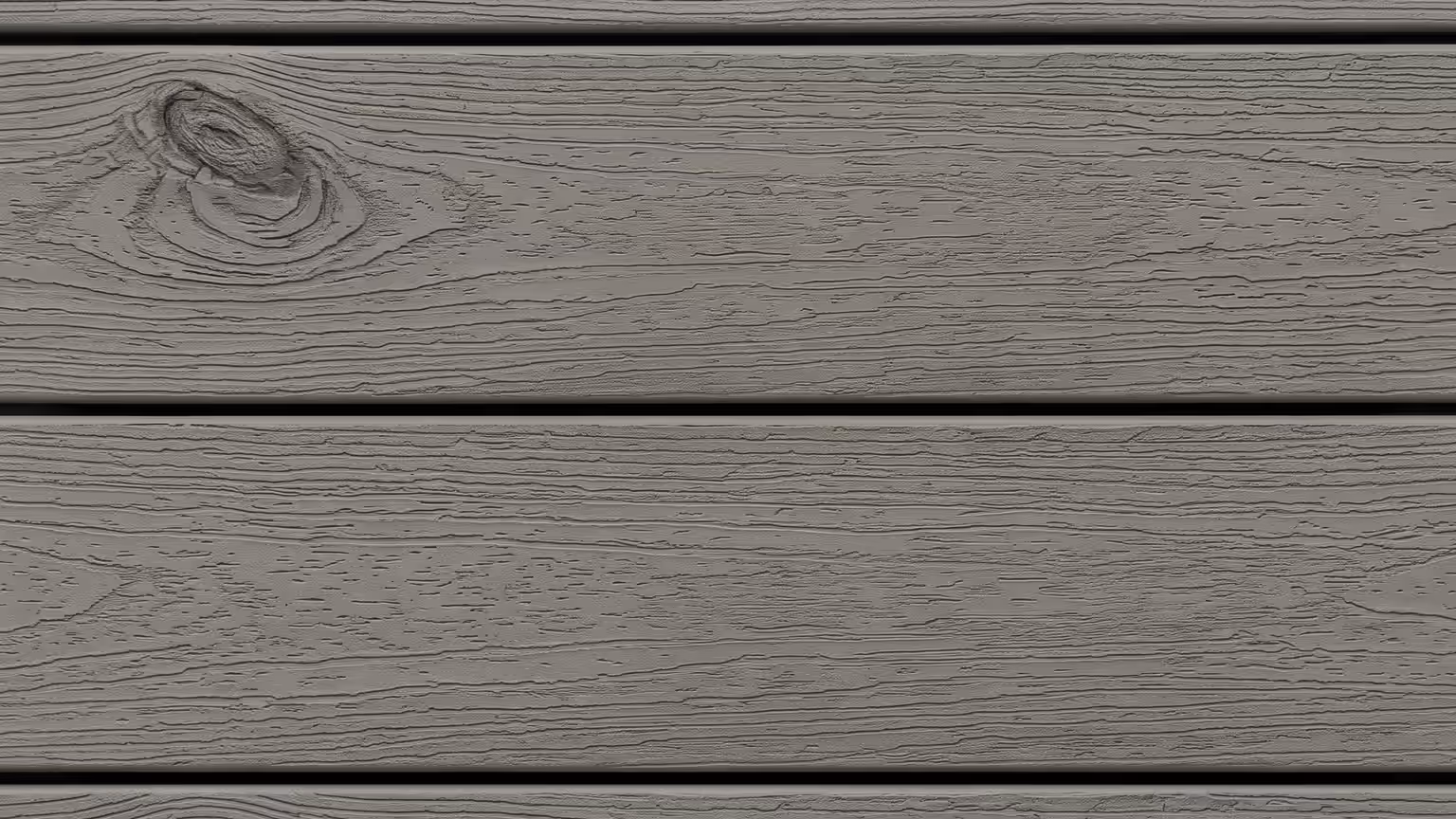 Grey capped composite deck boards with an embossed woodgrain texture and matte finish