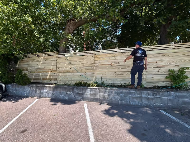 Newly built horizontal slat privacy fence in pressure-treated pine by Empirical Renovations in Vermont