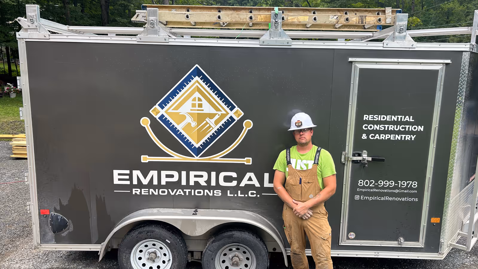 Gavin Williams, owner of Empirical Renovations, standing beside the company work trailer in Vermont